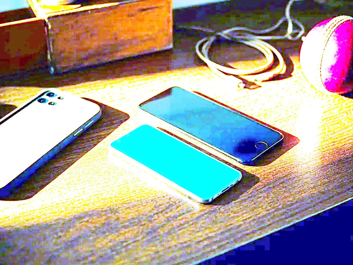 Smartphones arranged on a wooden desk for compatibility testing