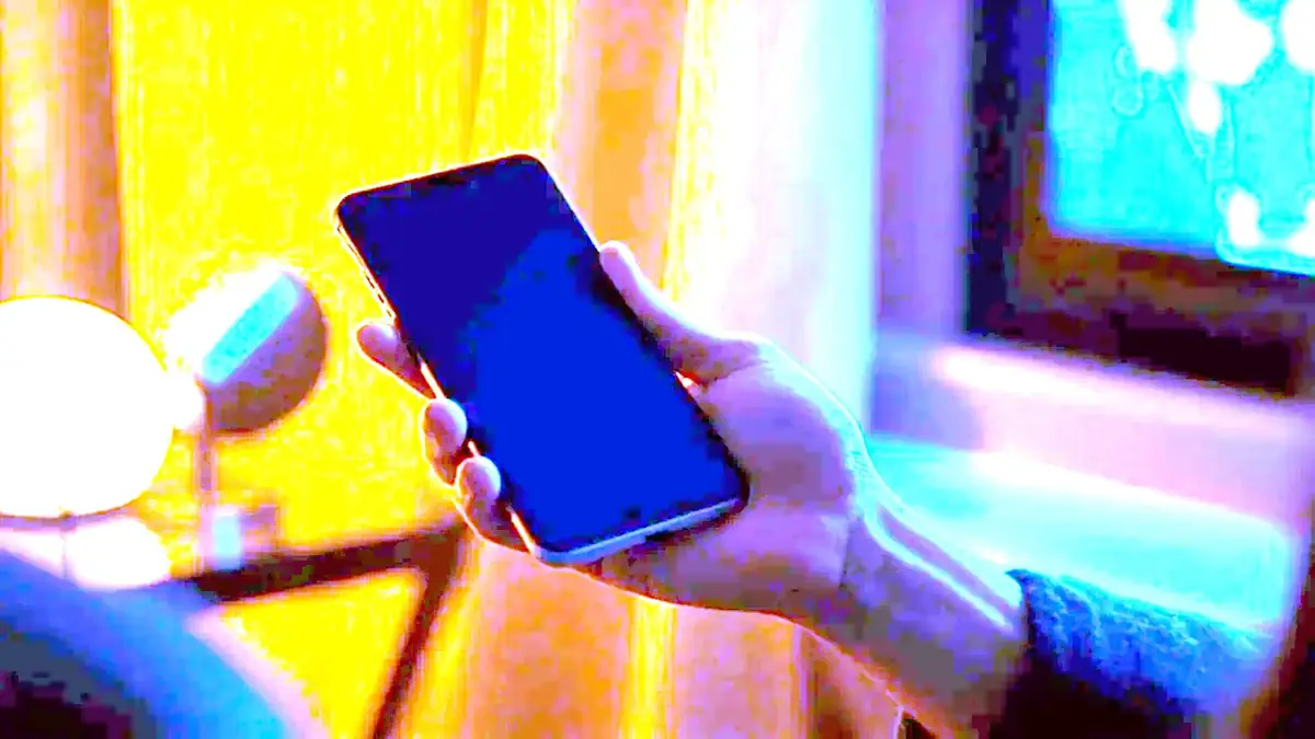 A smartphone screen showing an app download prompt on a wooden desk