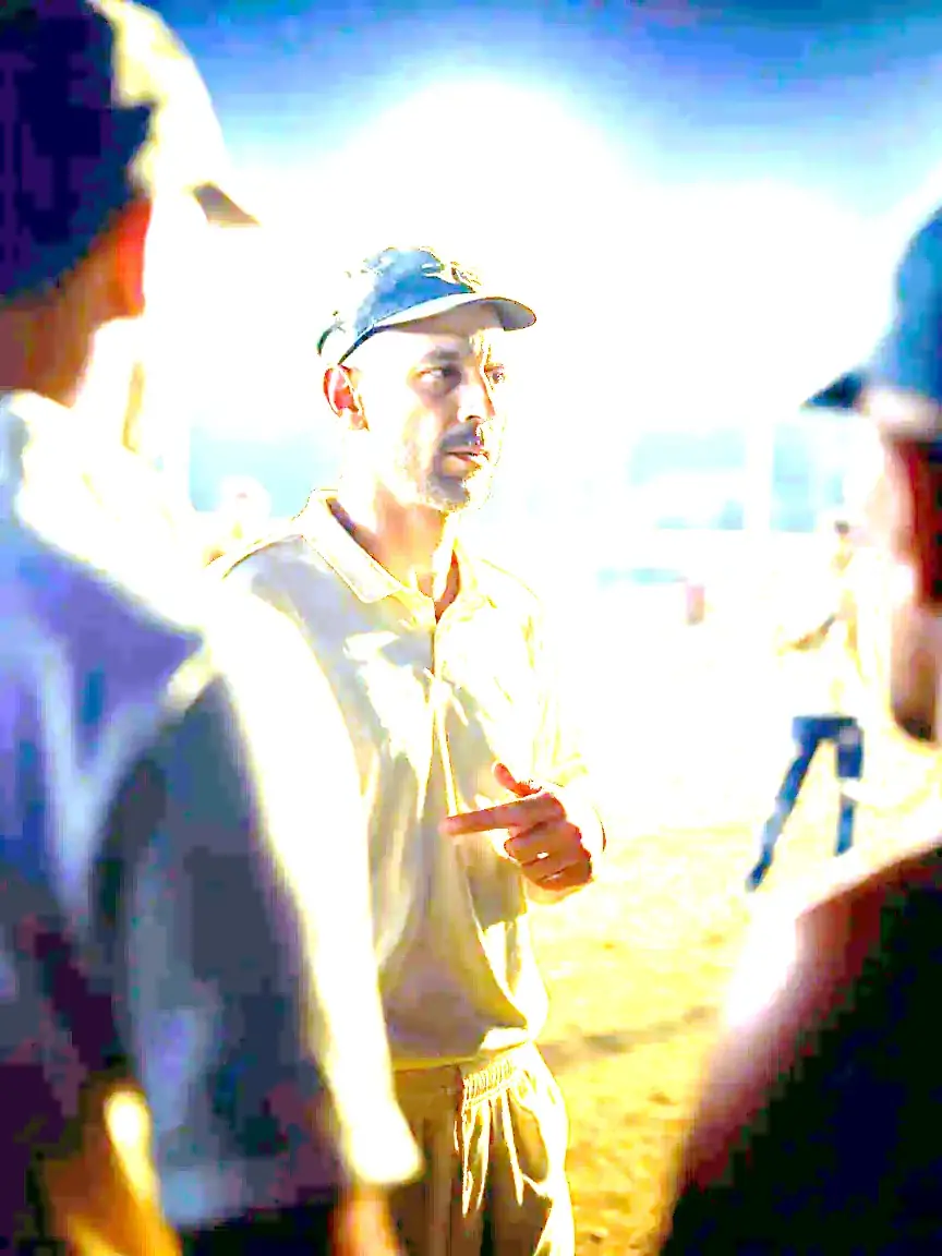 A captain addresses teammates during a night practice session