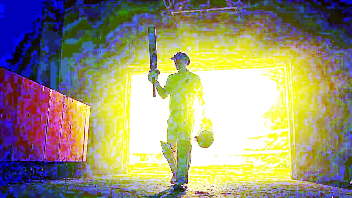 A cricketer warming up at the boundary ropes under stadium lights, bat in hand, deep pitch-brown shadow