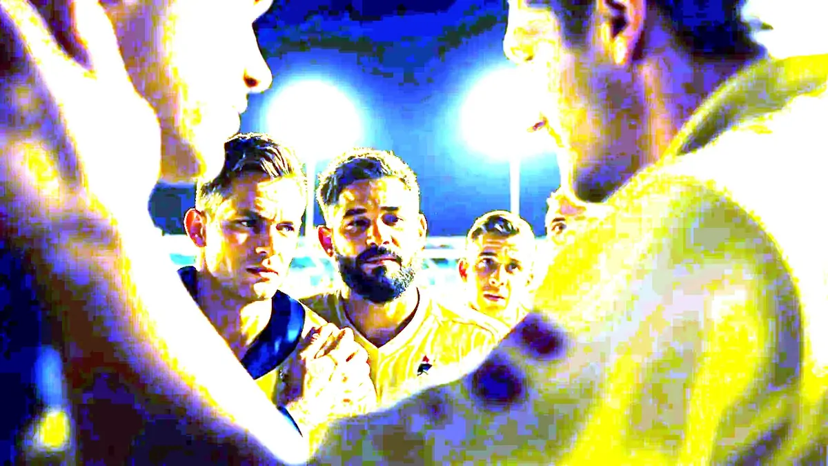 A cricket team huddles before a night match under floodlights